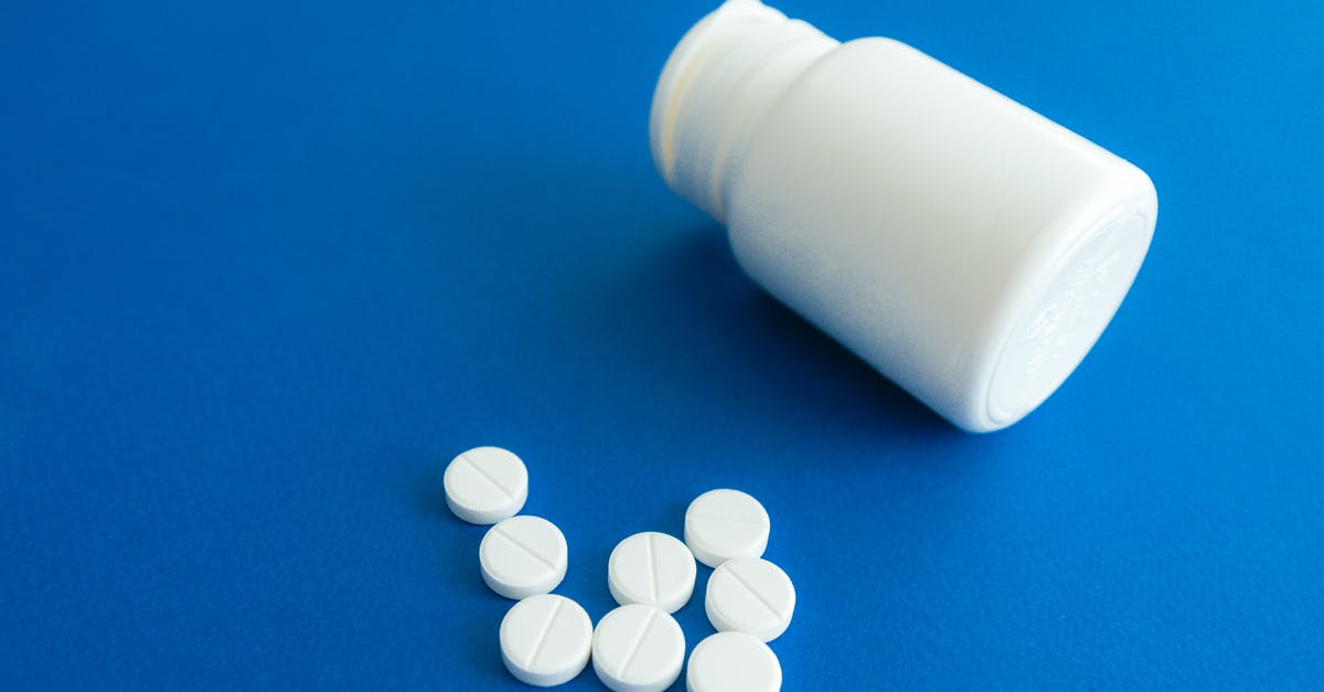Non-prescription medicines in India and USA - Medicine Tablets Beside a Plastic Container Non-prescription medicines in India and USA - Medicine Tablets Beside a Plastic Container