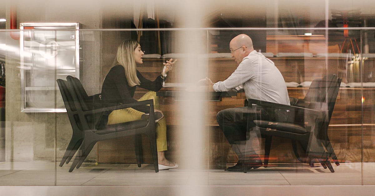 Obtaining Schegen visa for one country but never planning to go there - Man and Woman Sitting on Black Wooden Chairs Obtaining Schegen visa for one country but never planning to go there - Man and Woman Sitting on Black Wooden Chairs
