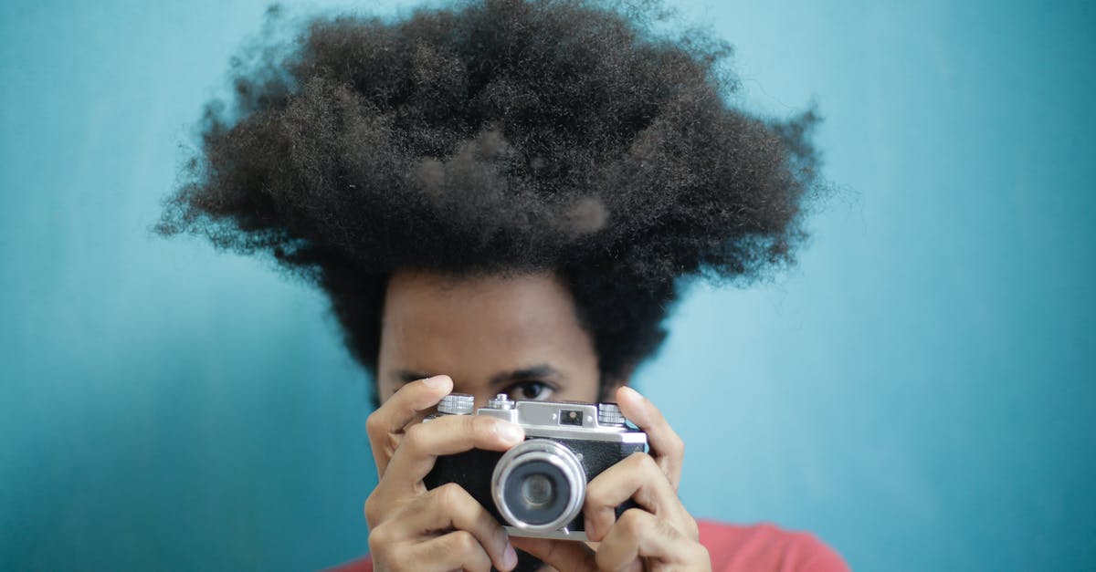 Old Windows Wallpaper Image 'shedinfield1024' - Can anyone tell me where this photo was taken? - Ethnic male with creative Afro hairstyle wearing pink t shirt taking pictures on retro photo camera against blue background while looking at camera Old Windows Wallpaper Image 'shedinfield1024' - Can anyone tell me where this photo was taken? - Ethnic male with creative Afro hairstyle wearing pink t shirt taking pictures on retro photo camera against blue background while looking at camera