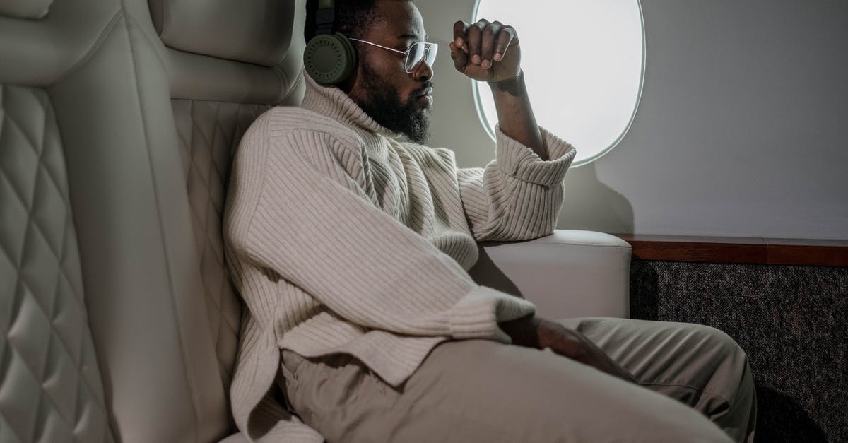 On landing in Paris, from India, which side of the plane to sit to see Eiffel tower? - Man Sitting Near the Airplane Window On landing in Paris, from India, which side of the plane to sit to see Eiffel tower? - Man Sitting Near the Airplane Window