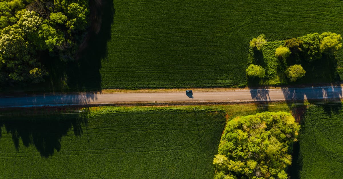 One-Way Car Rental from Yerevan to Tbilisi - Car driving through green fields on sunny day One-Way Car Rental from Yerevan to Tbilisi - Car driving through green fields on sunny day