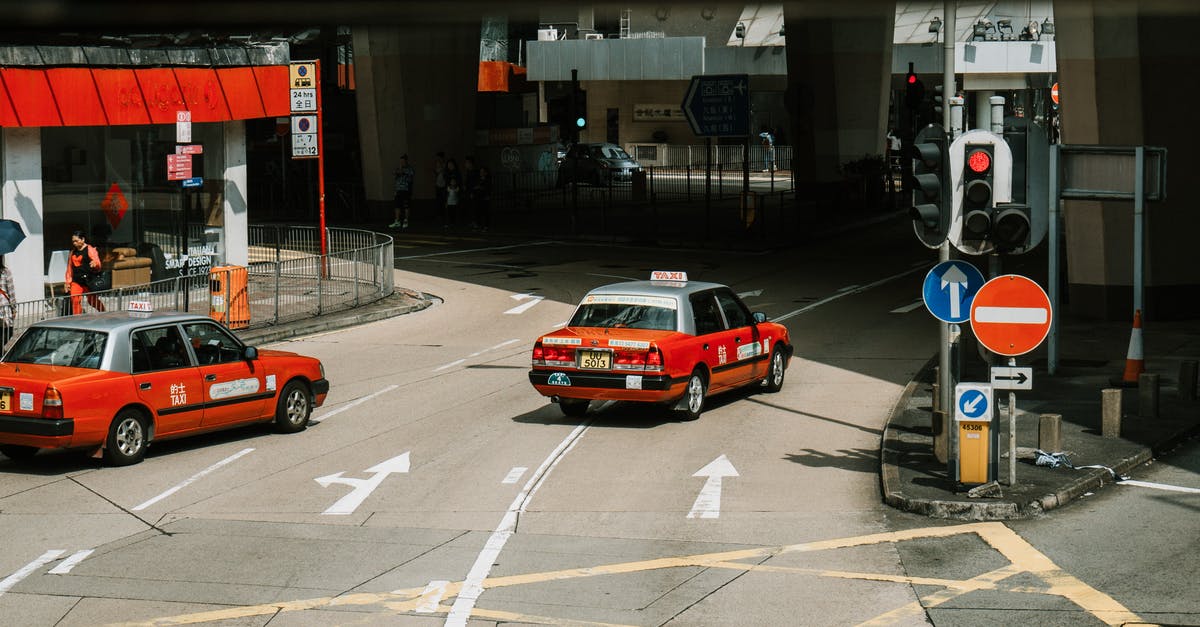 One-Way Car Rental from Yerevan to Tbilisi - From above of red taxi cars driving on asphalt street near crossroad in modern city district on sunny day One-Way Car Rental from Yerevan to Tbilisi - From above of red taxi cars driving on asphalt street near crossroad in modern city district on sunny day