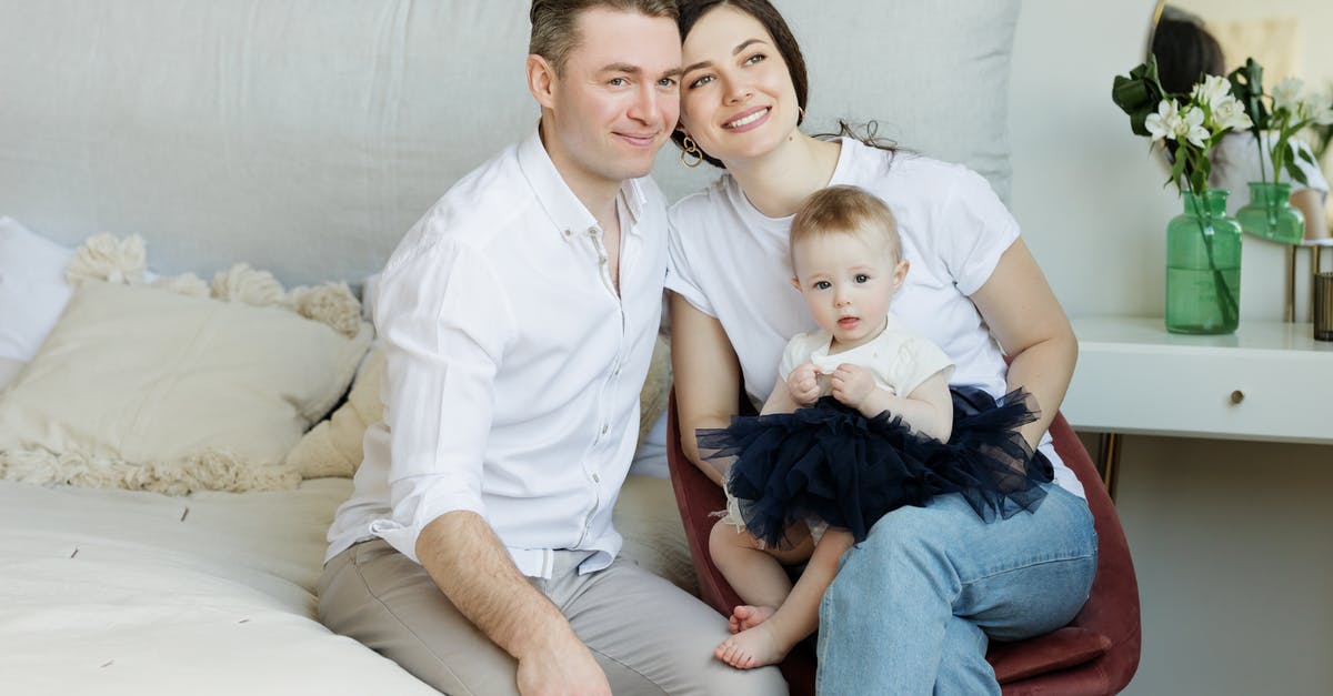 One-way ticket travelling to EU with non-EU wife and children - Photo of Couple with a Baby Sitting. One-way ticket travelling to EU with non-EU wife and children - Photo of Couple with a Baby Sitting.
