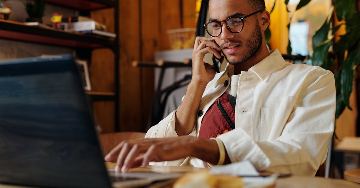 Online resource for finding cafes/wifi hotspots for working while traveling - Stylish Man in White Jacket and Eyeglasses having a Phonecall Online resource for finding cafes/wifi hotspots for working while traveling - Stylish Man in White Jacket and Eyeglasses having a Phonecall