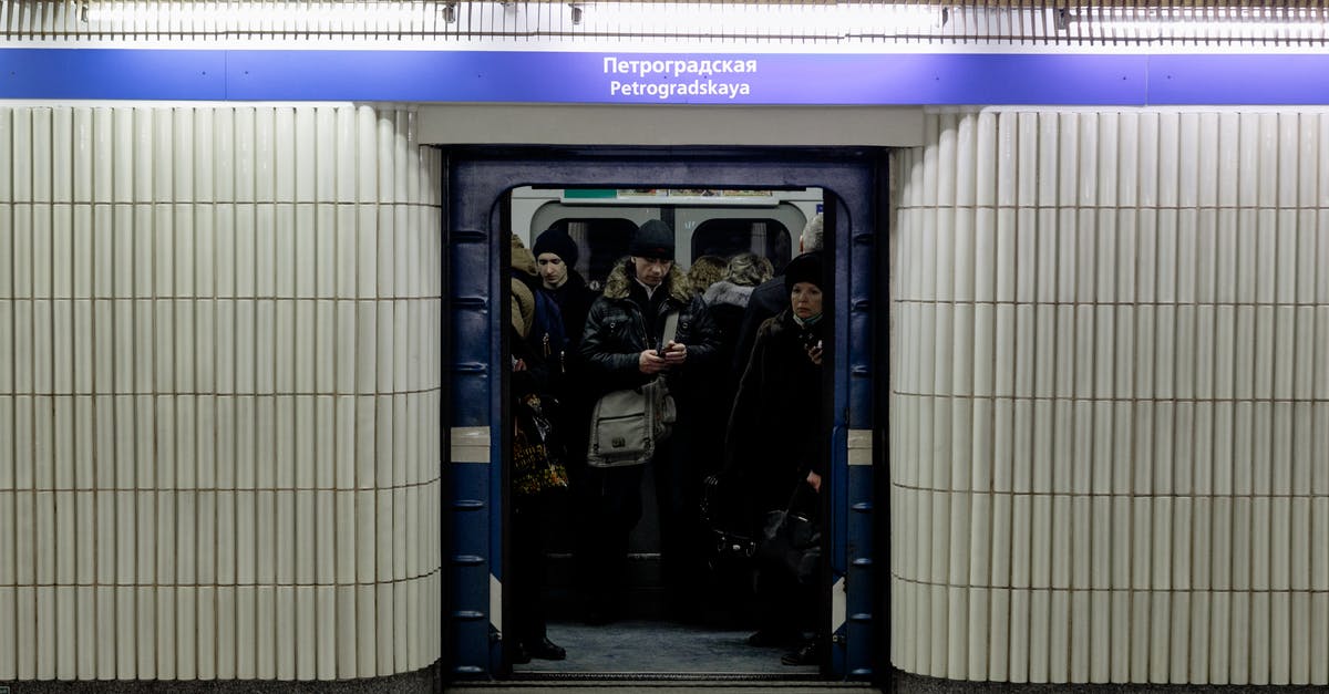 Open gates on the Paris Metro - Crop anonymous people in underground public transport against corridor with inscriptions under shiny light Open gates on the Paris Metro - Crop anonymous people in underground public transport against corridor with inscriptions under shiny light