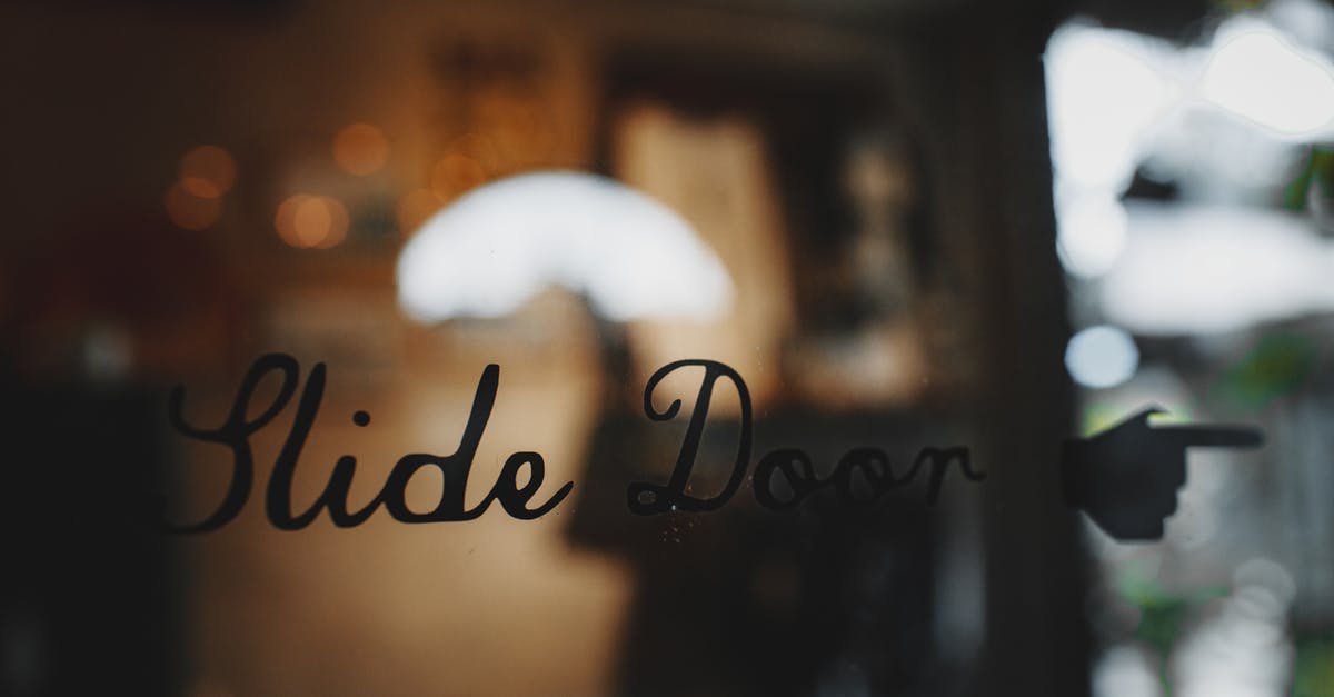 Open gates on the Paris Metro - Slide door inscription on glass entrance of modern cafe against blurred interior during daytime Open gates on the Paris Metro - Slide door inscription on glass entrance of modern cafe against blurred interior during daytime