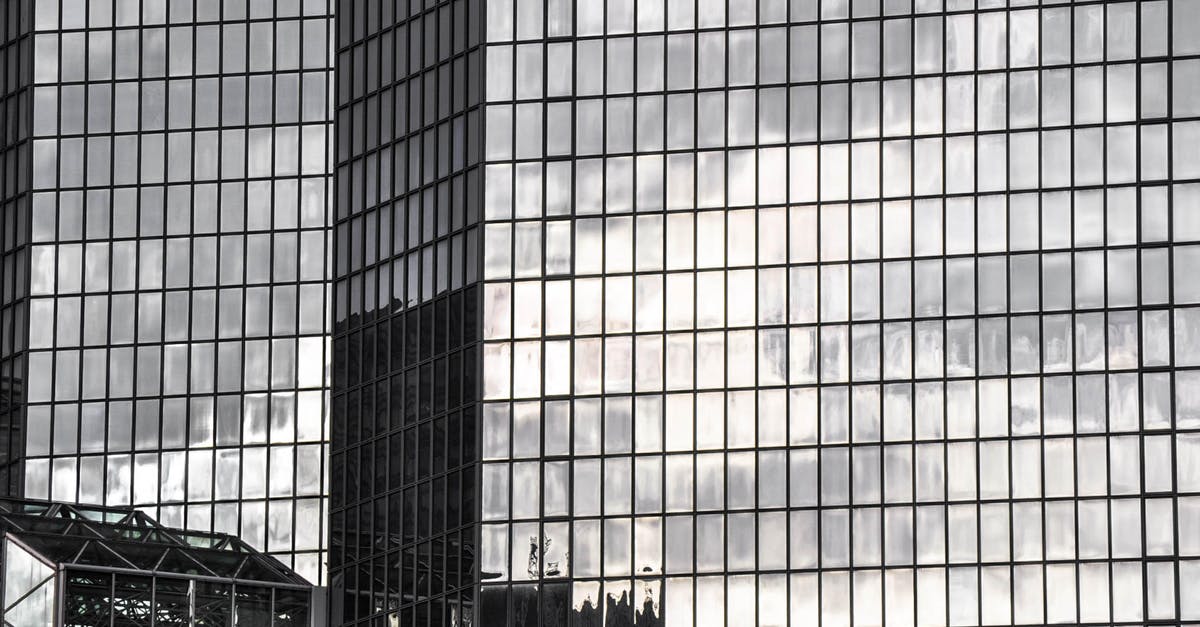 Opened closed cities in Murmansk Oblast - Close-up of a Modern Glass Building Reflecting Other Buildings in City Opened closed cities in Murmansk Oblast - Close-up of a Modern Glass Building Reflecting Other Buildings in City