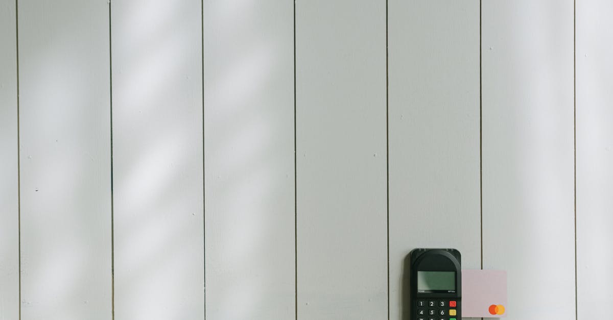 Opening a bank account with a quick debit card in Europe - Black and Gray Digital Device on Brown Wooden Table Opening a bank account with a quick debit card in Europe - Black and Gray Digital Device on Brown Wooden Table
