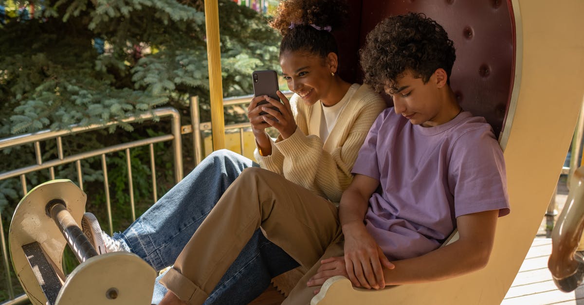 Opening hours in Maastricht, the Netherlands, for first day of year - Teenage couple sitting in carousel seat and girl taking selfie Opening hours in Maastricht, the Netherlands, for first day of year - Teenage couple sitting in carousel seat and girl taking selfie