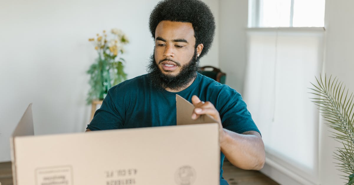 Optimal packing method for bras? - A Man Holding a Cardboard Box Optimal packing method for bras? - A Man Holding a Cardboard Box