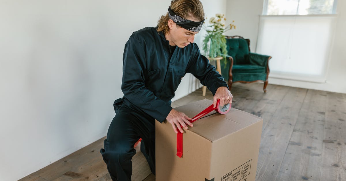 Optimal packing method for bras? - A Man Holding a Cardboard Box Optimal packing method for bras? - A Man Holding a Cardboard Box
