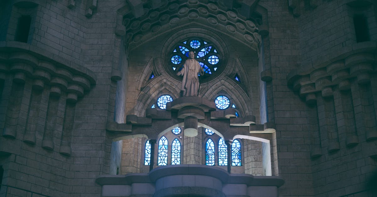 Optimum fares for transportations inside and around Barcelona (metro/trains) - From below of Sagrada Familia basilica in Barcelona with stained glass windows and sculpture near uneven walls Optimum fares for transportations inside and around Barcelona (metro/trains) - From below of Sagrada Familia basilica in Barcelona with stained glass windows and sculpture near uneven walls