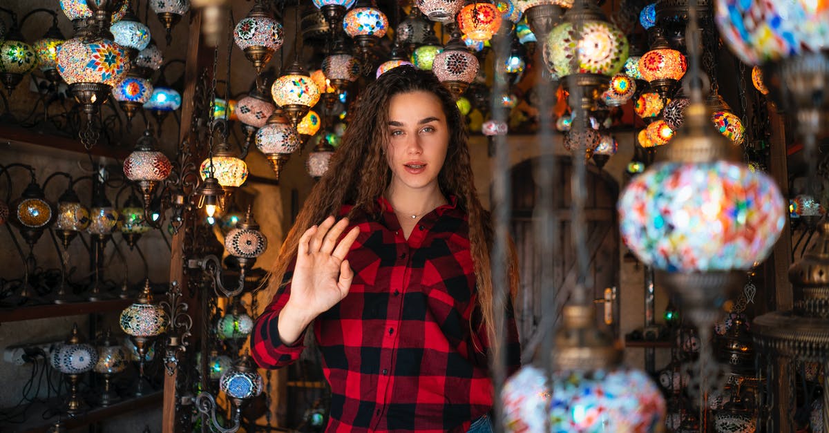 Options for getting from Kayseri (Turkey) to Goreme - Woman Surrounded by Mosaic Glass Lanterns Options for getting from Kayseri (Turkey) to Goreme - Woman Surrounded by Mosaic Glass Lanterns