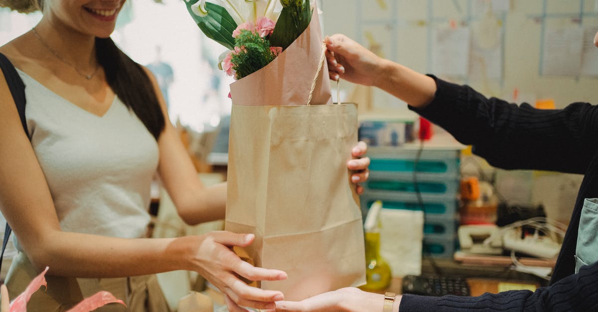Order Roma Pass online? - Flower shop assistant passing bag with bouquet Order Roma Pass online? - Flower shop assistant passing bag with bouquet