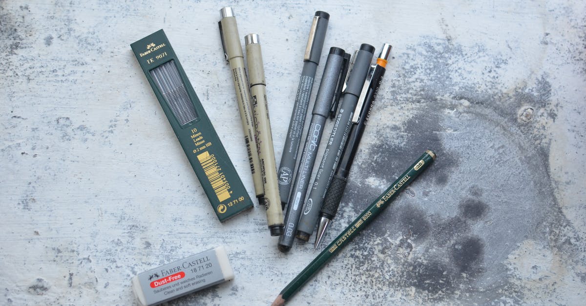 Ordering a bulky item in the USA - Top view of different pens and markers placed on shabby gray table for drawing Ordering a bulky item in the USA - Top view of different pens and markers placed on shabby gray table for drawing