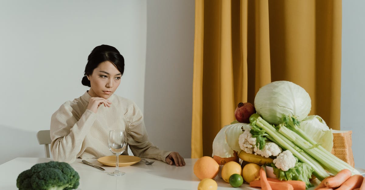 Organic Grocer in Tuscany? - Woman in White Long Sleeve Shirt Sitting Beside White Table With Vegetables Organic Grocer in Tuscany? - Woman in White Long Sleeve Shirt Sitting Beside White Table With Vegetables