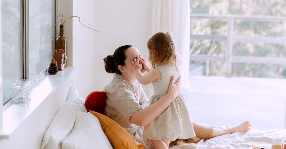 Organise a spa break over a weekend departing from West Sussex [closed] - Mother and daughter having fun in bedroom while spending time together at home