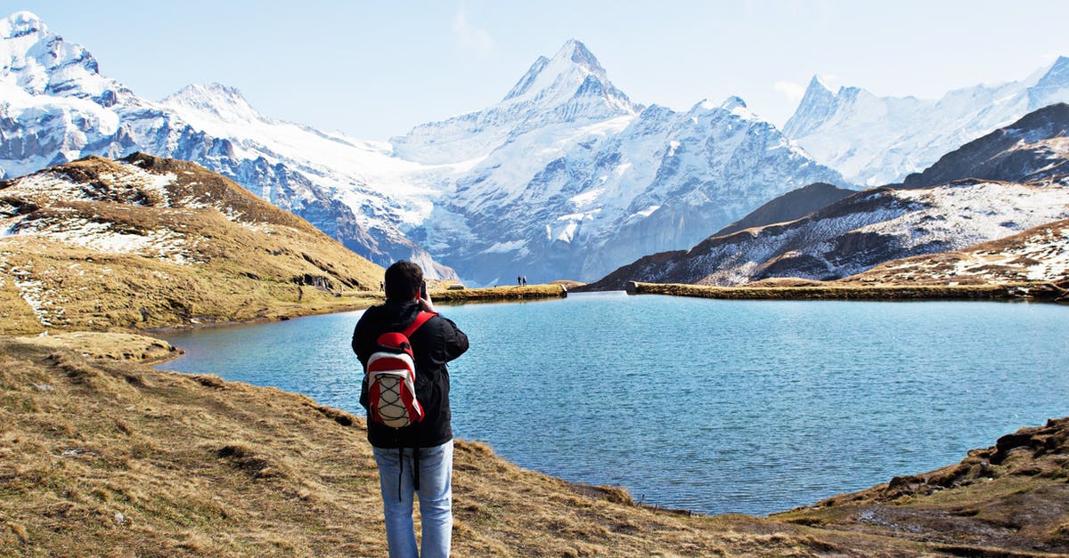 Organized outdoor backpacking tours in Europe/Asia/Africa? - Standing Man Wearing White and Red Backpack in Front of Calm Body of Water Organized outdoor backpacking tours in Europe/Asia/Africa? - Standing Man Wearing White and Red Backpack in Front of Calm Body of Water