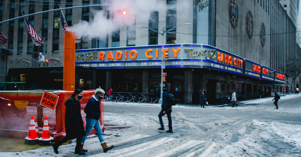 Outstanding medical bills in the US - Will I be held at the border? - Anonymous people walking in snowy city during coronavirus pandemic Outstanding medical bills in the US - Will I be held at the border? - Anonymous people walking in snowy city during coronavirus pandemic