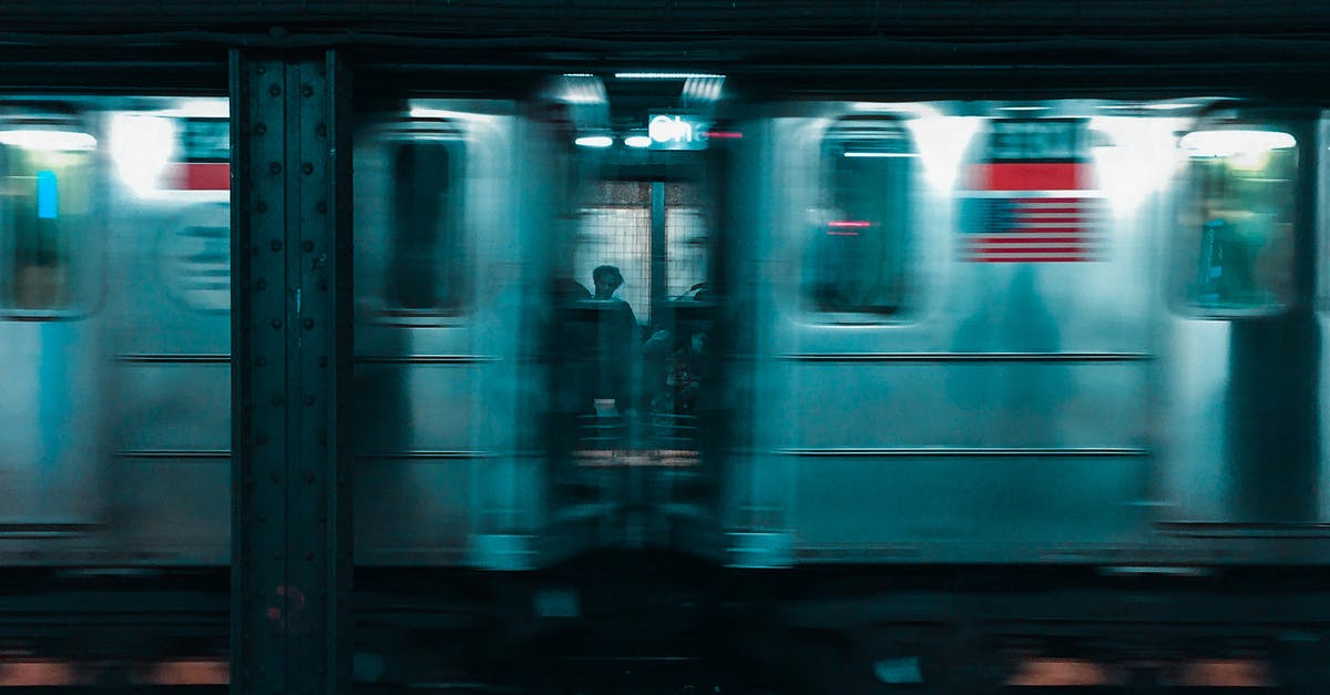 Overstayed VWP in the USA - White and Blue Train in Train Station Overstayed VWP in the USA - White and Blue Train in Train Station