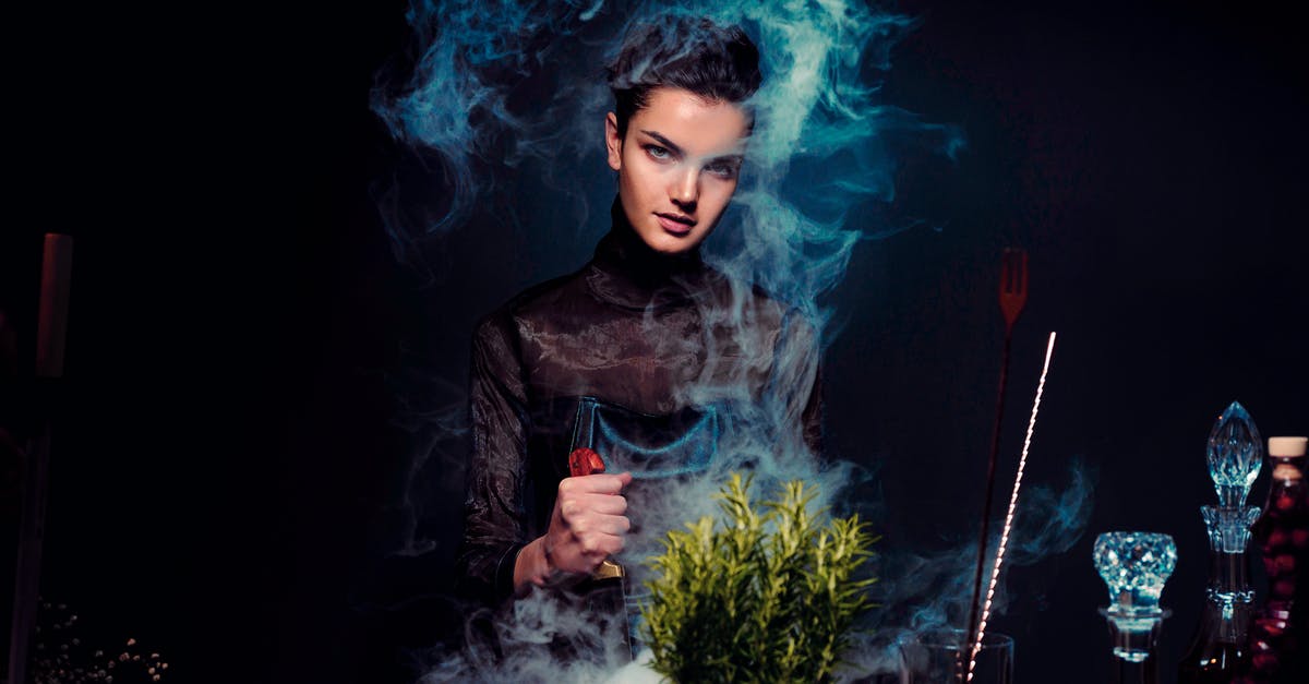 Overstaying grace period and reentering on an ESTA - Graceful young female alchemist with knife in hand in black outfit preparing potion from various herbs among smoke in dark room Overstaying grace period and reentering on an ESTA - Graceful young female alchemist with knife in hand in black outfit preparing potion from various herbs among smoke in dark room