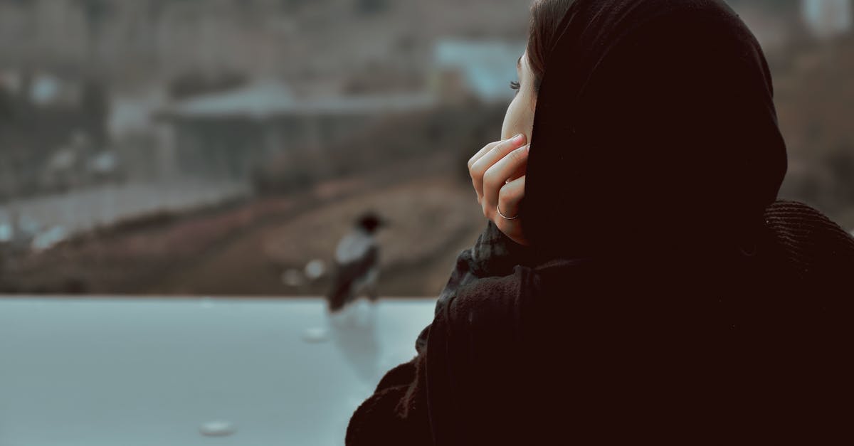 Overstaying in the US, is it possible to go to Guam and get back to LA? - Woman in Black Hoodie Looking at the Window Overstaying in the US, is it possible to go to Guam and get back to LA? - Woman in Black Hoodie Looking at the Window