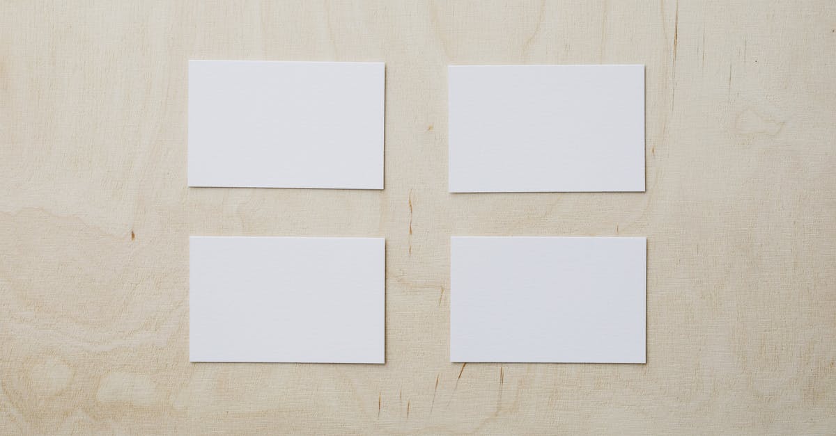 Oyster Card - how does it actually work? - Overhead view of clean white mockup greeting cards placed on light brown wooden desk