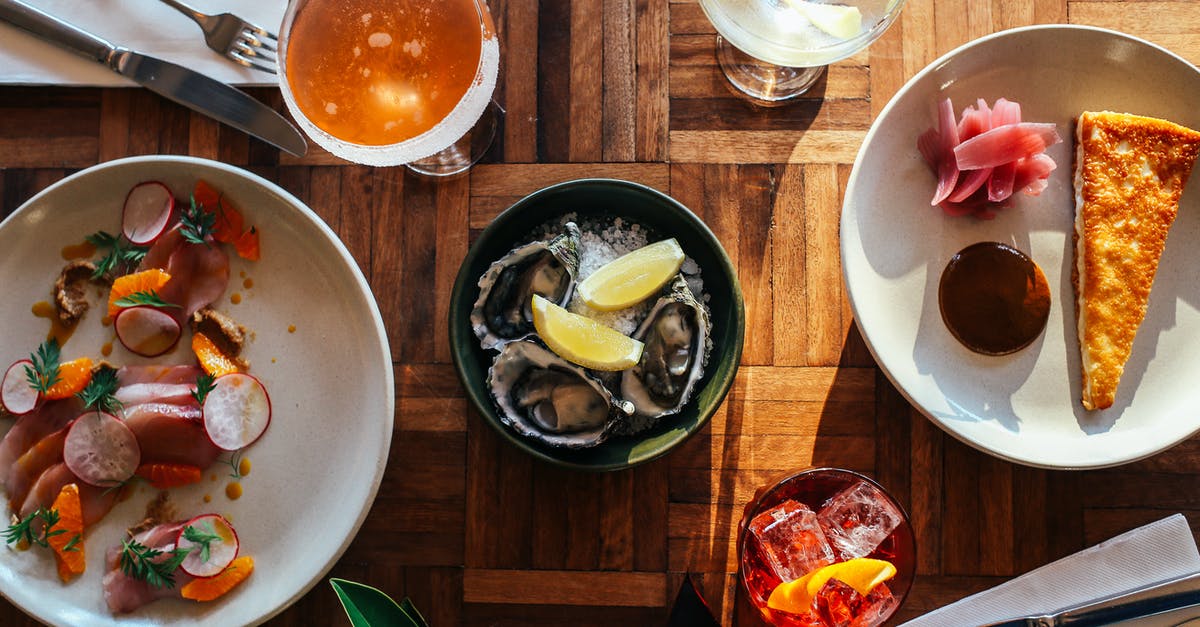 Oyster card—London only? - Top view of assorted cocktails and bowl of oysters served on wooden table near plate of fresh raw sliced fish and yummy dessert Oyster card—London only? - Top view of assorted cocktails and bowl of oysters served on wooden table near plate of fresh raw sliced fish and yummy dessert