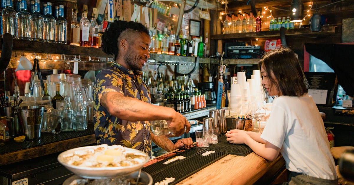 Oyster card—London only? - Bartender Preparing Cocktail for Customer at Bar Oyster card—London only? - Bartender Preparing Cocktail for Customer at Bar