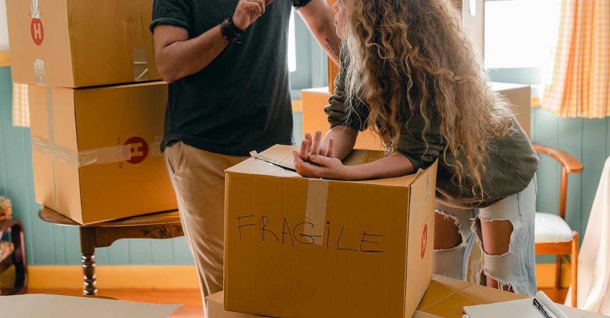 Pack of 10 tickets in Metro, Paris, can you share? - Woman and crop boyfriend near different boxes for moving Pack of 10 tickets in Metro, Paris, can you share? - Woman and crop boyfriend near different boxes for moving