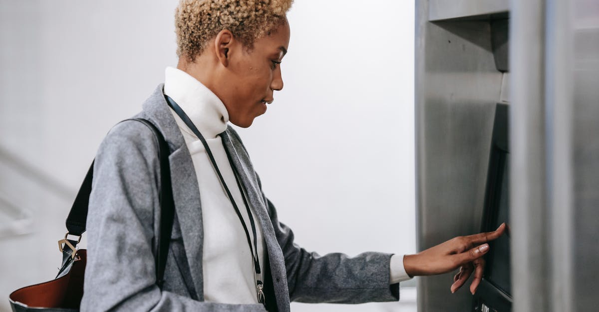 Palazzo Strozzi - is the online ticket queue shorter? - Young African American woman touching screen of ticket machine in metro station Palazzo Strozzi - is the online ticket queue shorter? - Young African American woman touching screen of ticket machine in metro station