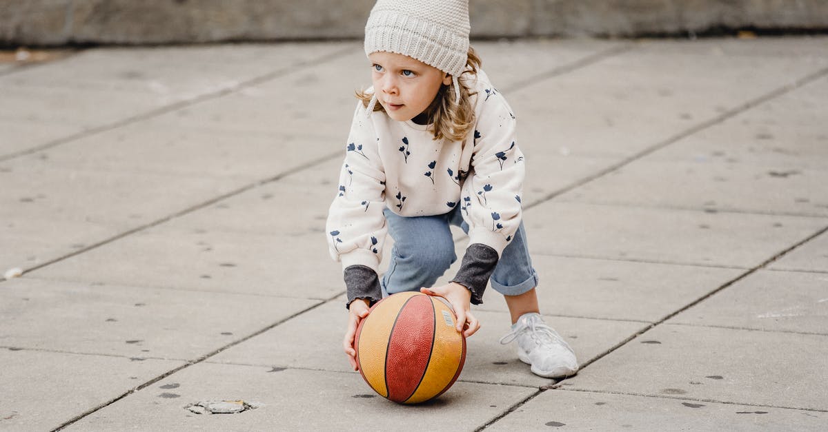 Park City, Utah for vacation - Girl playing with ball on street Park City, Utah for vacation - Girl playing with ball on street
