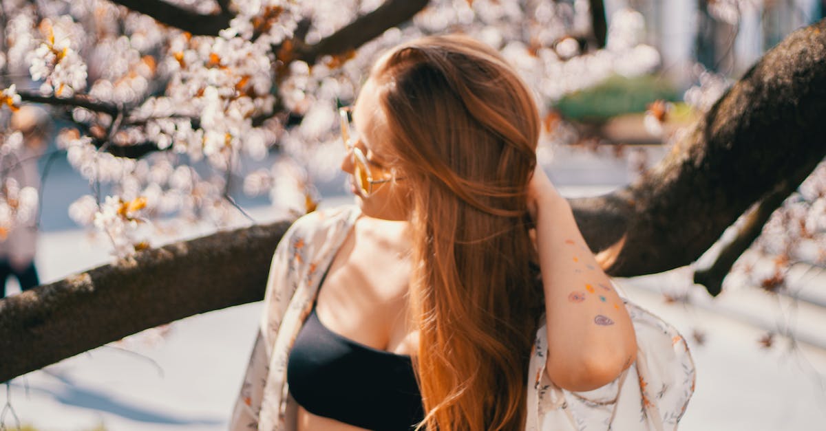 Park City, Utah for vacation - Young woman in summer garden with blooming trees Park City, Utah for vacation - Young woman in summer garden with blooming trees