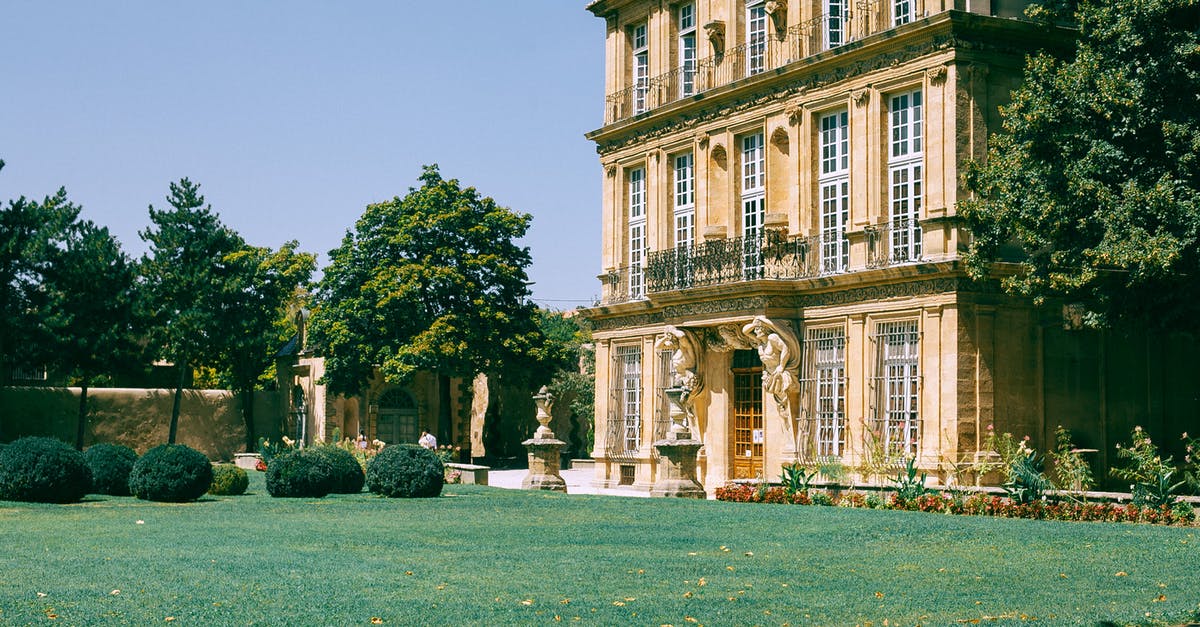 Parking fine in France - Old building with green lawn and bushes