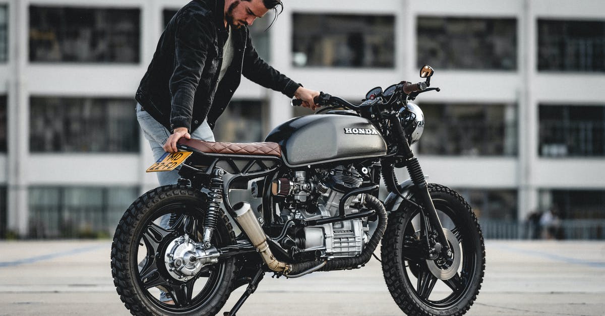 Parking rules for motorbikes in Rome, Italy - Selective Focus Photo of Man in Black Jacket Parking Black Honda Cafe Racer Motorcycle Parking rules for motorbikes in Rome, Italy - Selective Focus Photo of Man in Black Jacket Parking Black Honda Cafe Racer Motorcycle