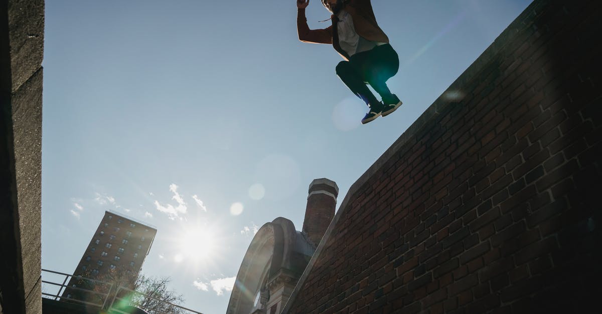 Parkour - Tricking - Free-running in Tokyo? - Determined male tracer jumping from brick wall Parkour - Tricking - Free-running in Tokyo? - Determined male tracer jumping from brick wall