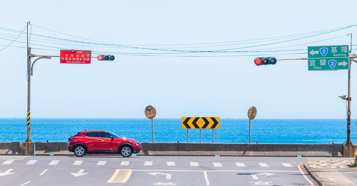 Passing border in car not owned by me - A Red Car Passing the Road Passing border in car not owned by me - A Red Car Passing the Road
