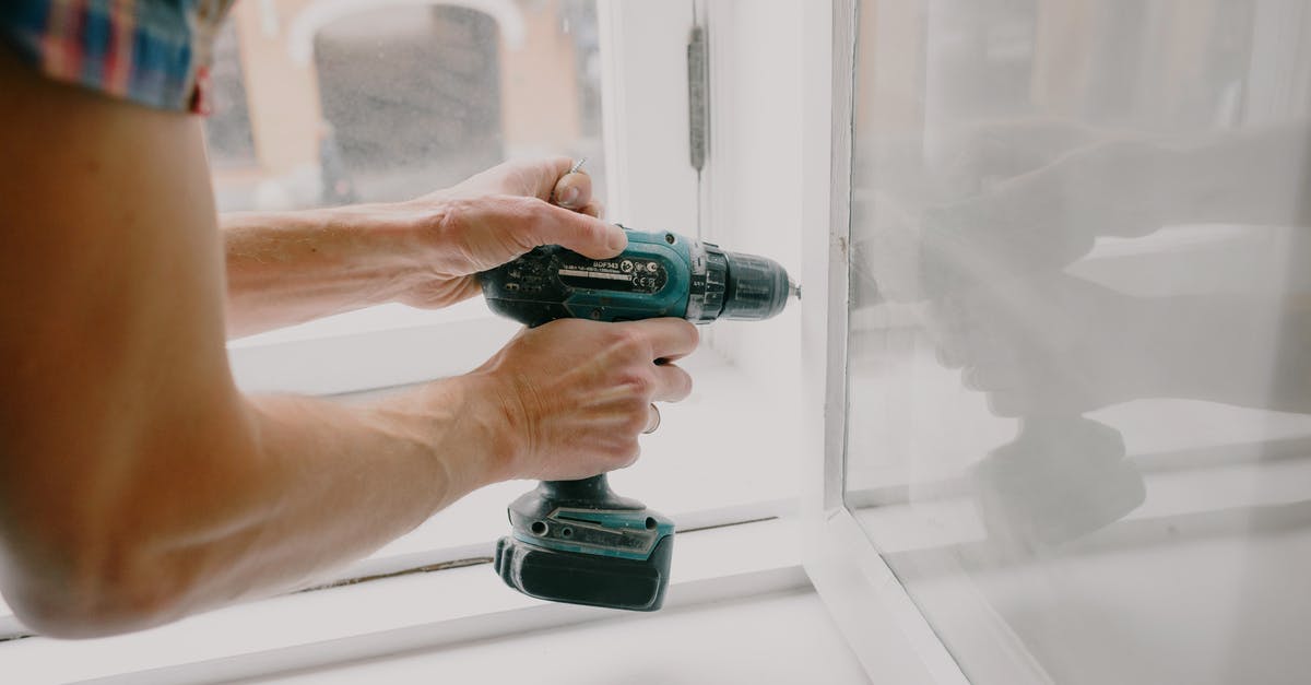 Passport renewal and six-month rule - Workman screwing window frame during housework Passport renewal and six-month rule - Workman screwing window frame during housework
