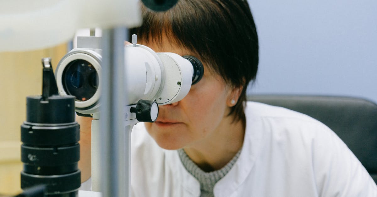 Passport request from IRCC through the VAC office - Photo Of Woman Looking Through Slit Lamp Passport request from IRCC through the VAC office - Photo Of Woman Looking Through Slit Lamp