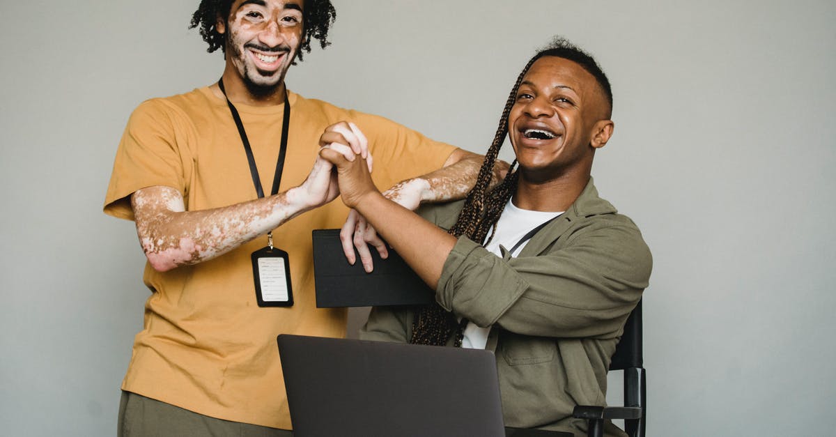 Passports with different names, check-in, ticket name, and immigration problem! - Smiling black coworkers holding hands in studio Passports with different names, check-in, ticket name, and immigration problem! - Smiling black coworkers holding hands in studio