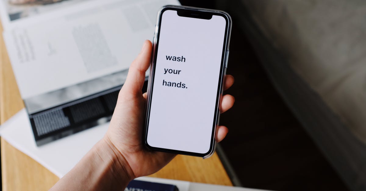 People exempt from Trump's COVID-19 proclamation, what is the quarantine/screening requirement? - Crop unrecognizable person showing smartphone screen with inscription at home People exempt from Trump's COVID-19 proclamation, what is the quarantine/screening requirement? - Crop unrecognizable person showing smartphone screen with inscription at home