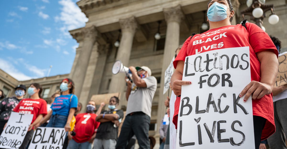 People exempt from Trump's COVID-19 proclamation, what is the quarantine/screening requirement? - Unrecognizable person with sign on protest People exempt from Trump's COVID-19 proclamation, what is the quarantine/screening requirement? - Unrecognizable person with sign on protest