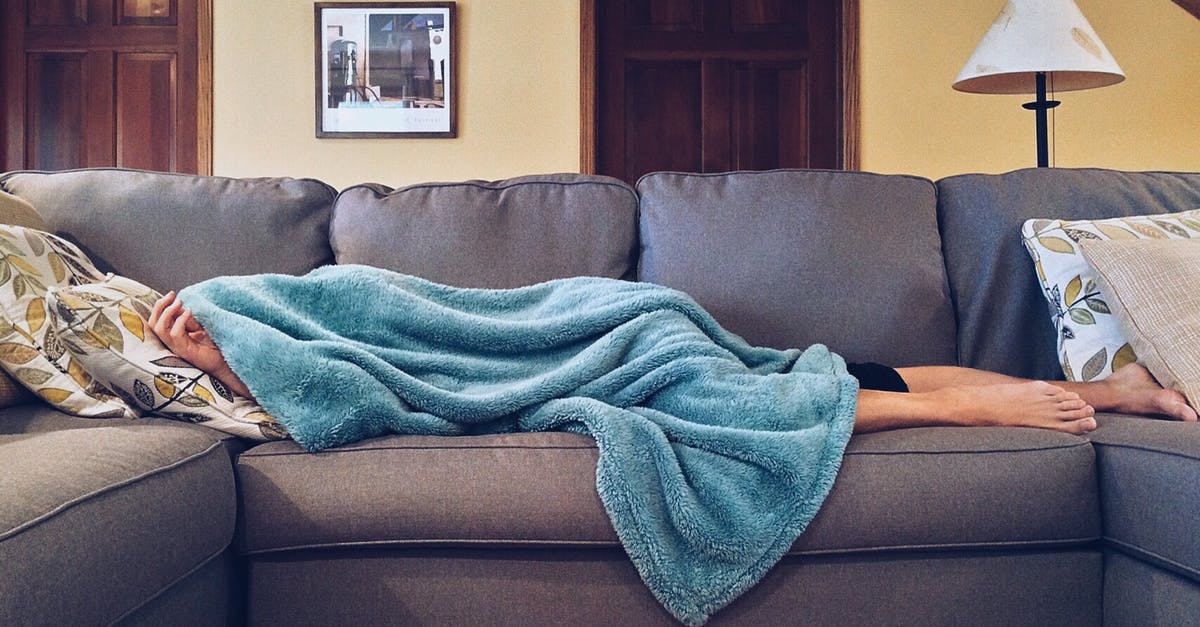 People in the next room in my hotel are having noisy sex; I can't sleep! What to do? - Person Lying on Sofa