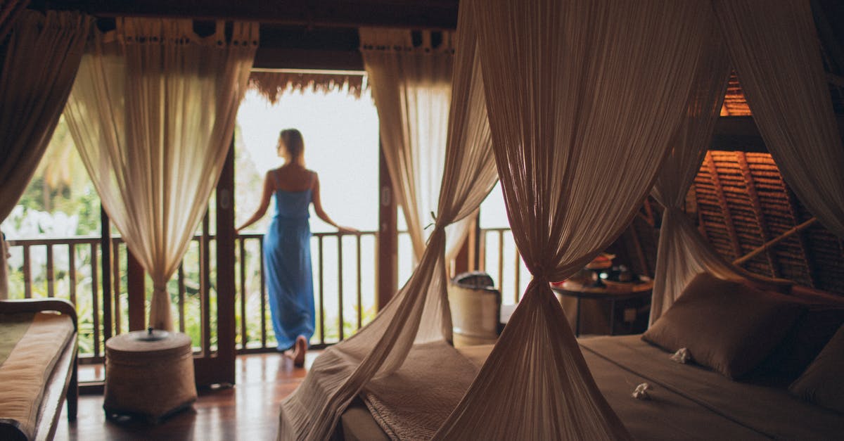 People in the next room in my hotel are having noisy sex; I can't sleep! What to do? - Woman Leaning on Handrail in Room
