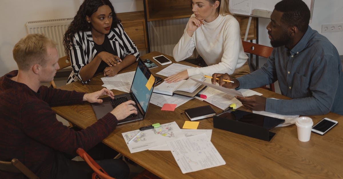 Personal Visit on Business Visa Type C - Interracial Group of People Discussing at the Table