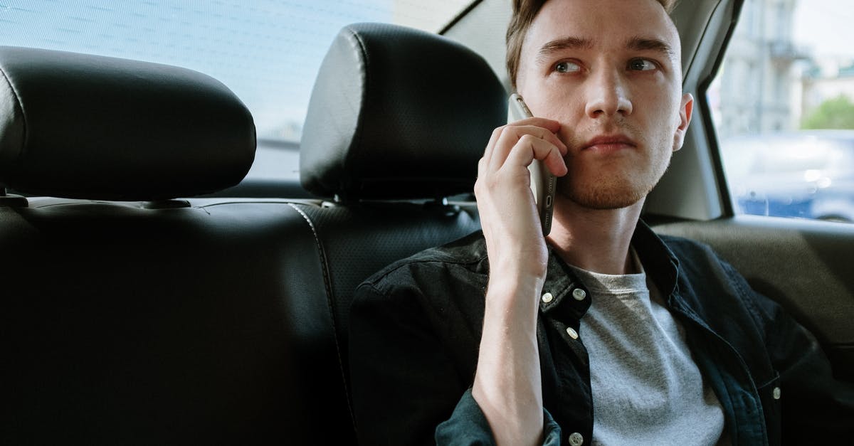 Phone service crossing borders, Vietnam>Thailand>Laos>Cambodia - Man in Gray Button Up Shirt Sitting on Black Leather Car Seat Phone service crossing borders, Vietnam>Thailand>Laos>Cambodia - Man in Gray Button Up Shirt Sitting on Black Leather Car Seat