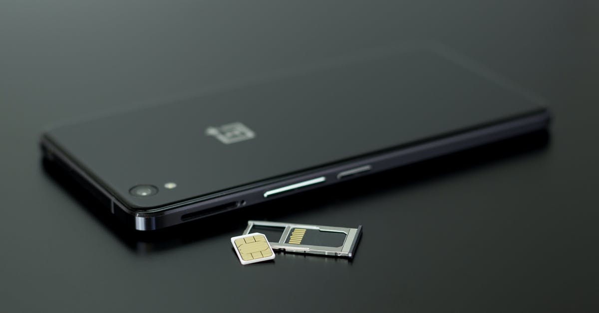 Phone SIM Card for multiple countries - Black Smartphone on Black Table Top Phone SIM Card for multiple countries - Black Smartphone on Black Table Top