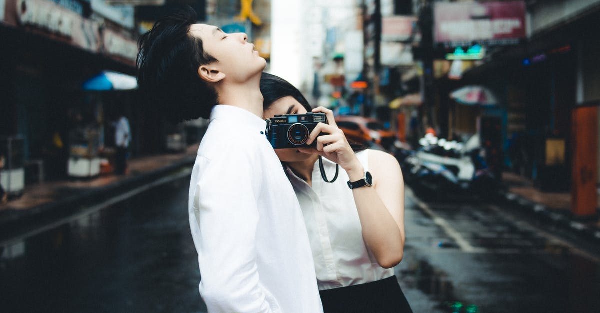 Photography and Running in the Christiania Neighbourhood of Copenhagen - Elegant Asian couple with photo camera on road Photography and Running in the Christiania Neighbourhood of Copenhagen - Elegant Asian couple with photo camera on road