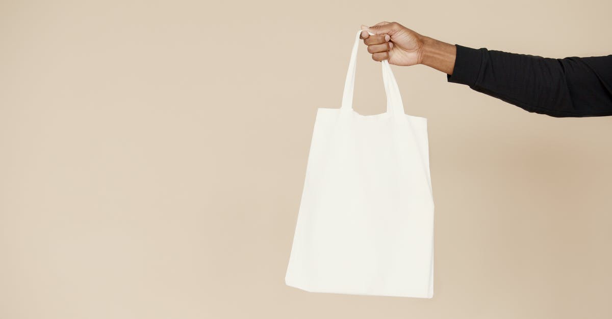 Pick up full tank, return empty policy - Person Holding White Paper Bag Pick up full tank, return empty policy - Person Holding White Paper Bag