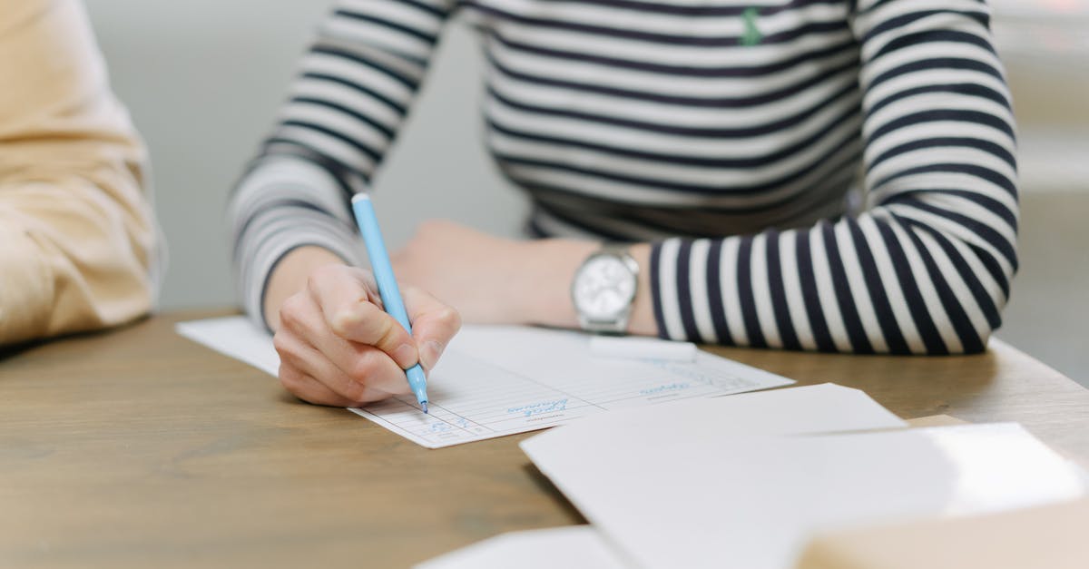 Planning to ask a long-term visa after tourism visa: which documents to pass the border? [closed] - An Employee Writing on a Document with a Colored Pen